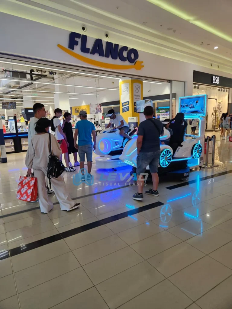 Player driving a VR racing simulator with VR headset in a commercial arcade